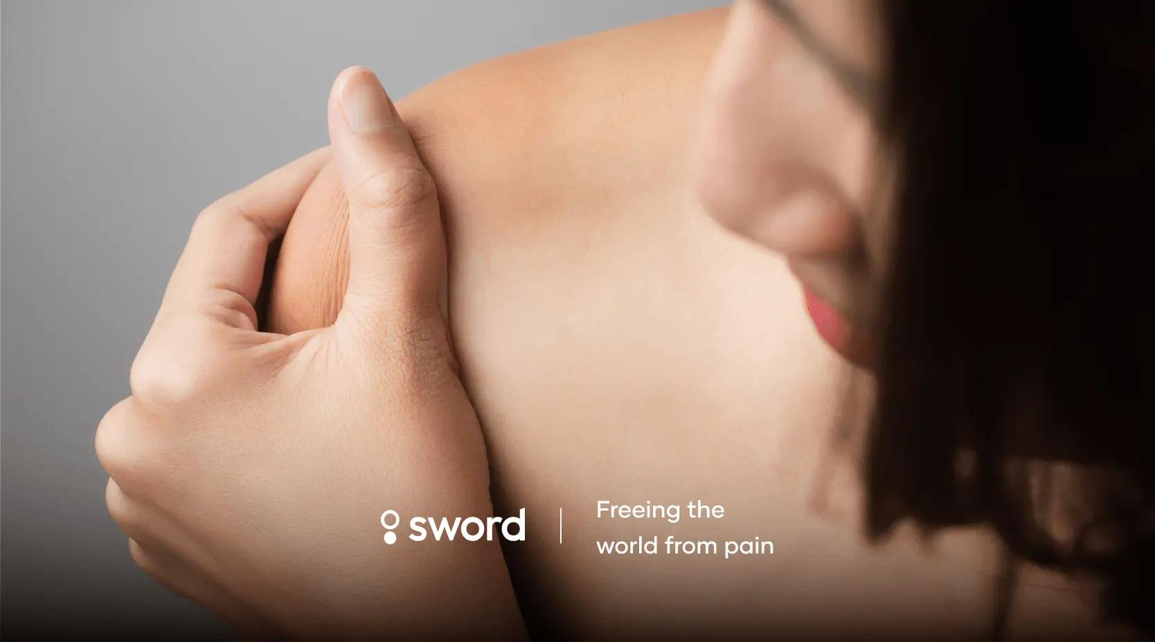 Person holding their shoulder with text "sword" and "Freeing the world from pain" on a blurred background.