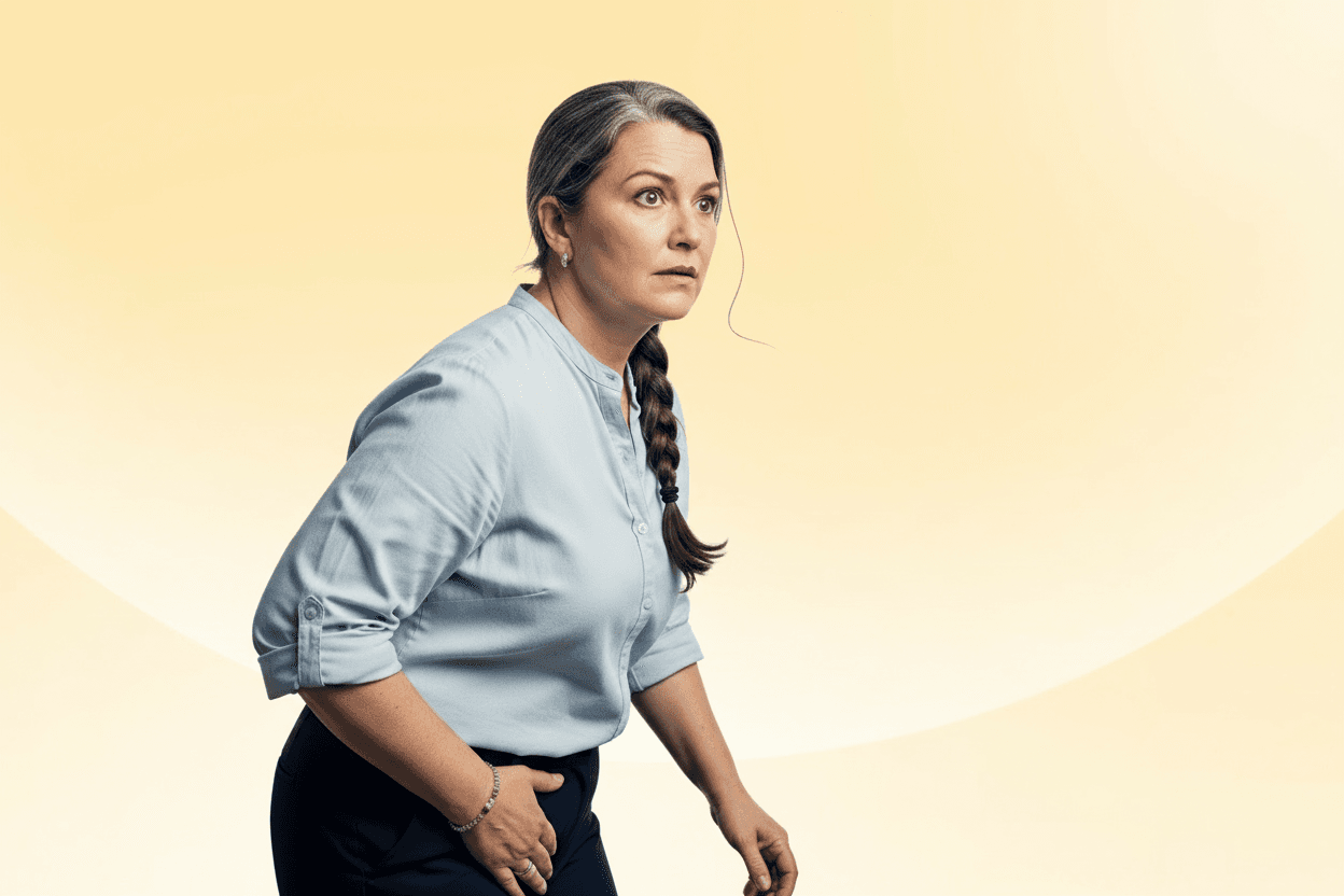 A woman with a braid and light blue shirt looks concerned, standing against a soft yellow background.