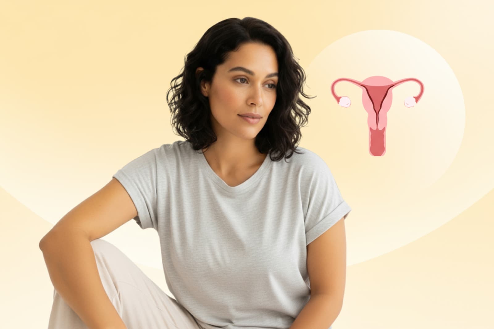 Woman in a gray shirt sits thoughtfully against a soft yellow background with an illustration of a uterus beside her.