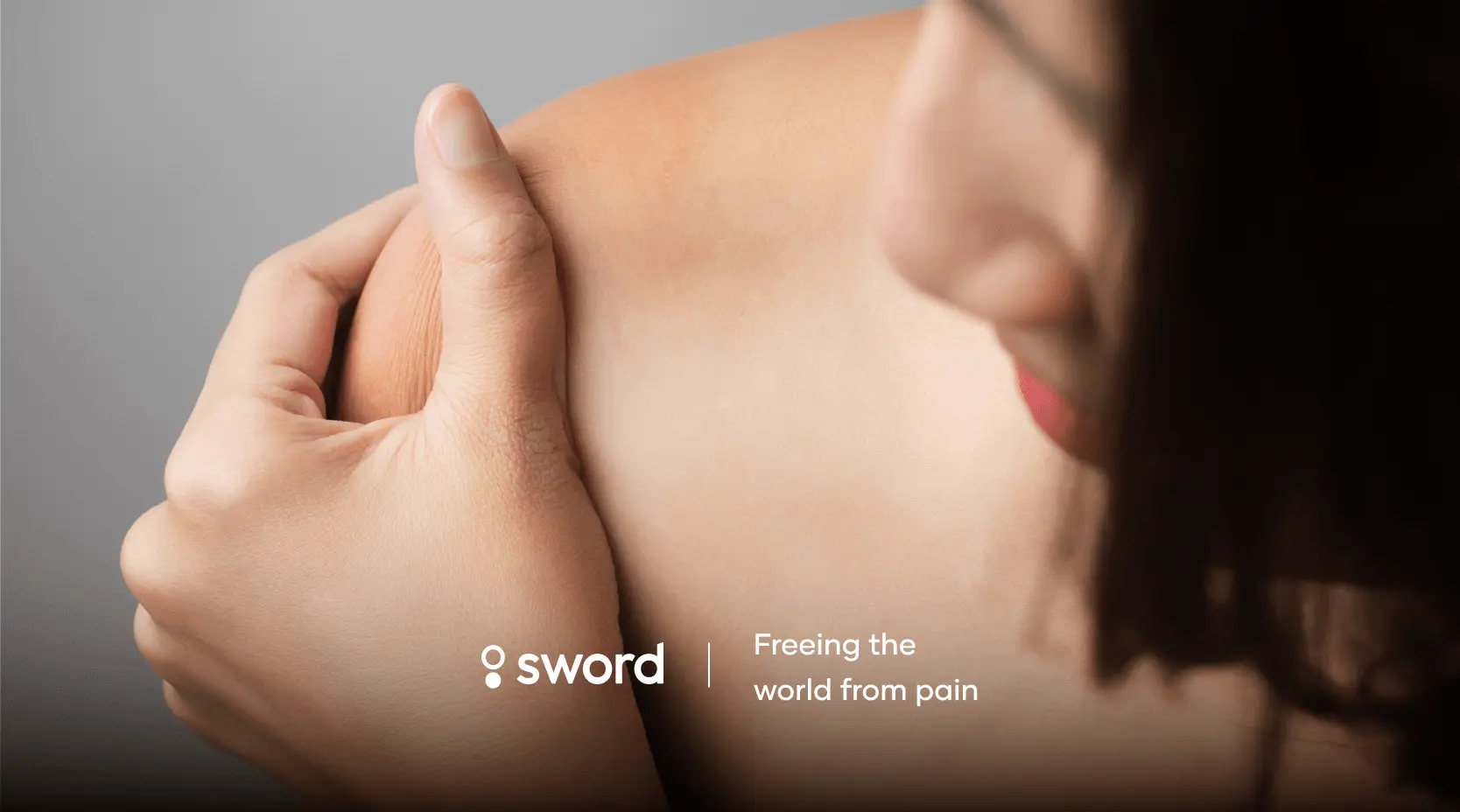 Person holding their shoulder, with the text "sword" and "Freeing the world from pain" visible.