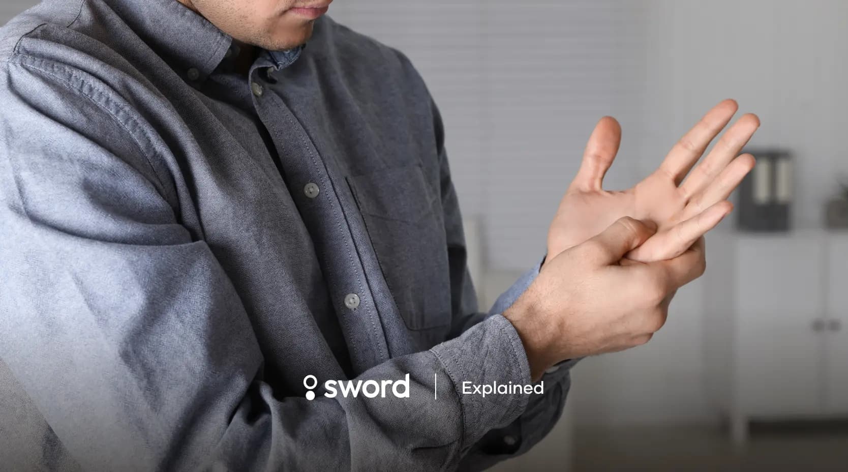 Person in a gray shirt massaging their wrist, with the words "sword Explained" at the bottom.
