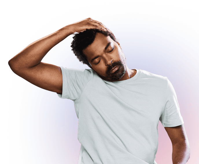 A man wearing a light gray T-shirt gently stretches his neck by tilting his head to one side and holding it with his hand. His eyes are closed and the background is a soft gradient.