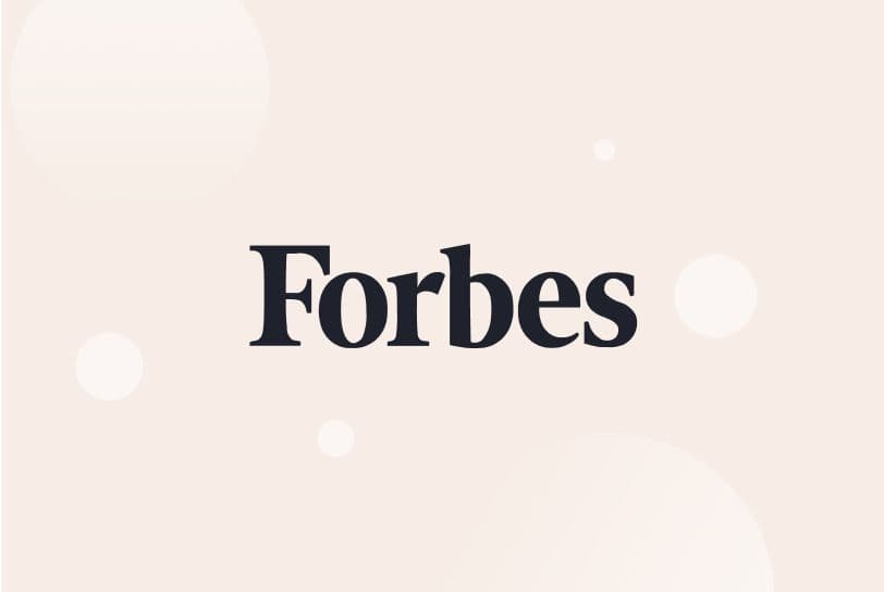 Dark blue Forbes logo on cream background